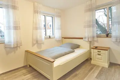 Ein Bett oder Betten in einem Zimmer der Unterkunft Zur Friedenseiche