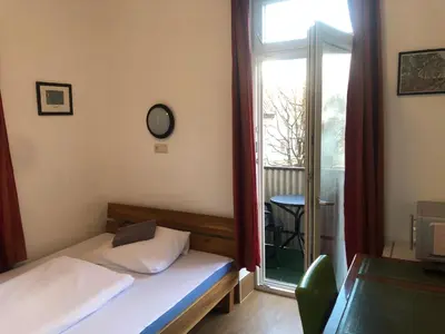 Ein Bett oder Betten in einem Zimmer der Unterkunft Hotel Pension Schmellergarten