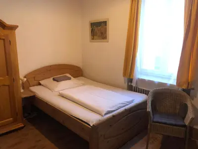 Ein Bett oder Betten in einem Zimmer der Unterkunft Hotel Pension Schmellergarten