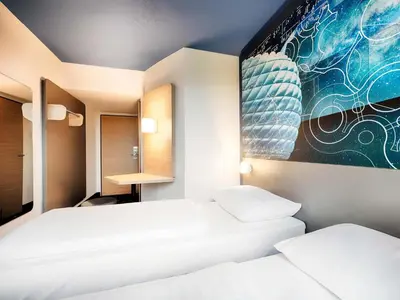 Ein Bett oder Betten in einem Zimmer der Unterkunft B&B Hotel München-Garching