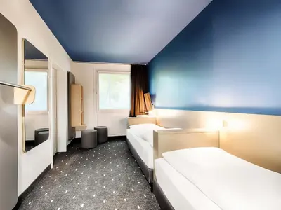 Ein Bett oder Betten in einem Zimmer der Unterkunft B&B Hotel München-Garching