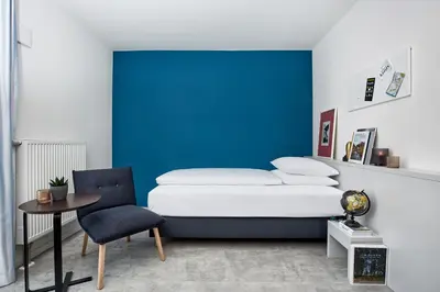 Ein Bett oder Betten in einem Zimmer der Unterkunft H.ome Serviced Apartments München