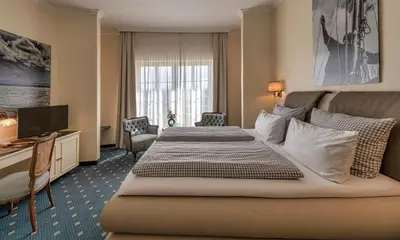 Ein Bett oder Betten in einem Zimmer der Unterkunft Hotel Starnberger See