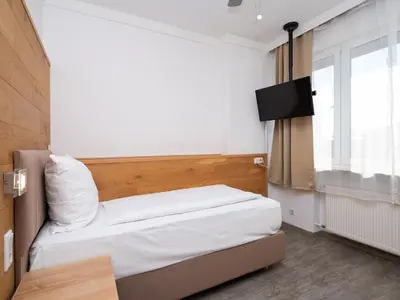 Ein Bett oder Betten in einem Zimmer der Unterkunft DONAUHOTEL Ingolstadt
