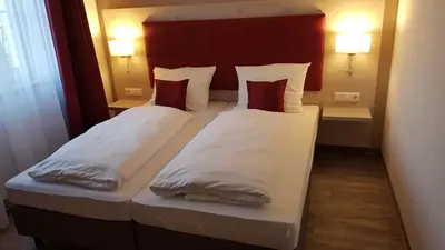 Ein Bett oder Betten in einem Zimmer der Unterkunft Gästehaus Stahuber