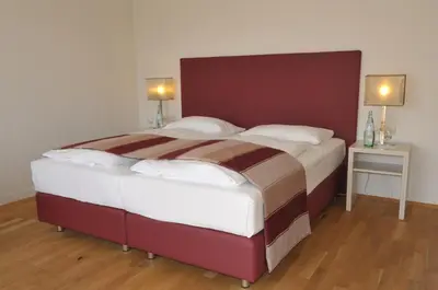 Ein Bett oder Betten in einem Zimmer der Unterkunft Ambassador Parkhotel