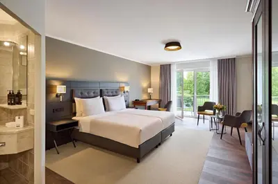 Ein Bett oder Betten in einem Zimmer der Unterkunft Dorint MARC AUREL Spa & Golf Resort