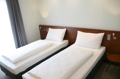 Ein Bett oder Betten in einem Zimmer der Unterkunft Augusten Hotel München