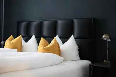 Ein Bett oder Betten in einem Zimmer der Unterkunft Hotel Mühldorf