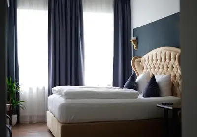 Ein Bett oder Betten in einem Zimmer der Unterkunft Hotel Mühldorf