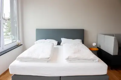 Ein Bett oder Betten in einem Zimmer der Unterkunft Das Fischer Boardinghouse BW