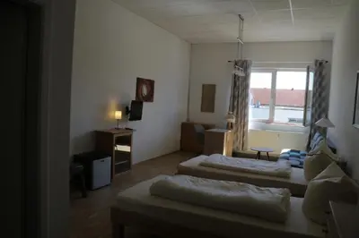 Ein Bett oder Betten in einem Zimmer der Unterkunft Pension Isartal