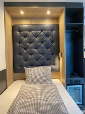 Ein Bett oder Betten in einem Zimmer der Unterkunft Munich Deluxe Hotel