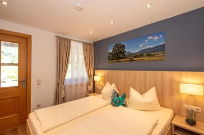 Ein Bett oder Betten in einem Zimmer der Unterkunft Aparthotel Werdenfels