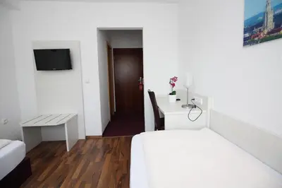 Ein Bett oder Betten in einem Zimmer der Unterkunft Hotel Olympia
