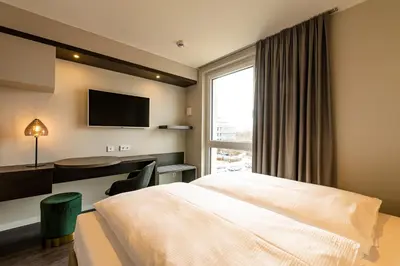 Ein Bett oder Betten in einem Zimmer der Unterkunft MASEVEN München Messe Dornach