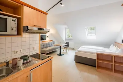 Ein Bett oder Betten in einem Zimmer der Unterkunft Mikro Apartments Erding