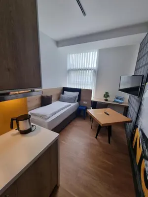 Ein Bett oder Betten in einem Zimmer der Unterkunft my MINGA Airport serviced Apartments