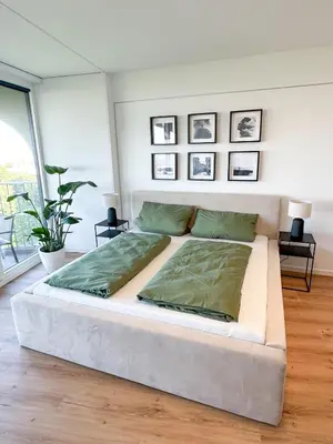 Ein Bett oder Betten in einem Zimmer der Unterkunft Helles Apartment mit tollem Blick über Augsburg