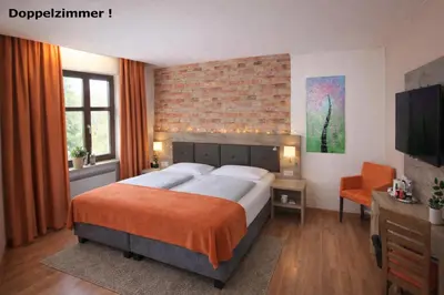 Ein Bett oder Betten in einem Zimmer der Unterkunft B&B Landhotel Römerkessel