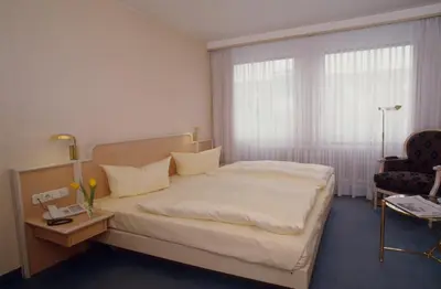 Ein Bett oder Betten in einem Zimmer der Unterkunft Hotel Ambiente Garni