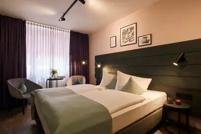 Ein Bett oder Betten in einem Zimmer der Unterkunft Hotel Mirabell by Maier Privathotels