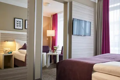 Ein Bett oder Betten in einem Zimmer der Unterkunft Hotel Mirabell by Maier Privathotels