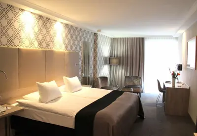 Ein Bett oder Betten in einem Zimmer der Unterkunft Hotel Erzgiesserei Europe
