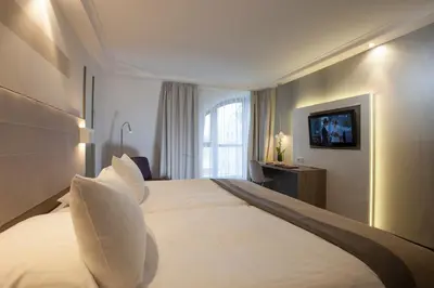 Ein Bett oder Betten in einem Zimmer der Unterkunft Hotel Erzgiesserei Europe