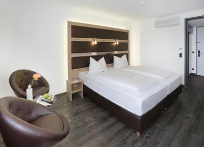 Ein Bett oder Betten in einem Zimmer der Unterkunft Michel Hotel Landshut Kaiserhof an der Isar Stadtzentrum