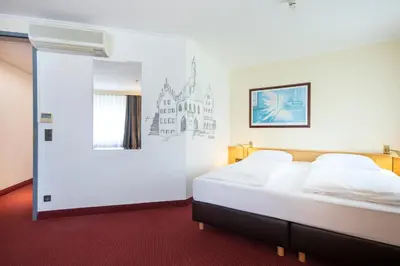 Ein Bett oder Betten in einem Zimmer der Unterkunft Michel Hotel Landshut Kaiserhof an der Isar Stadtzentrum