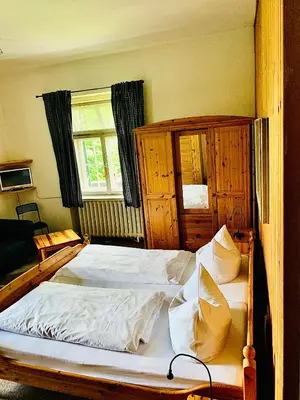 Ein Bett oder Betten in einem Zimmer der Unterkunft Gästehaus Hohe Tannen