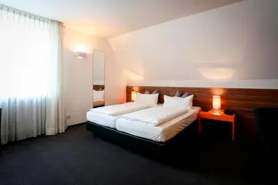 Ein Bett oder Betten in einem Zimmer der Unterkunft Hotel Schempp
