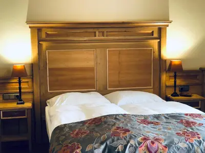 Ein Bett oder Betten in einem Zimmer der Unterkunft Ampervilla Hotel