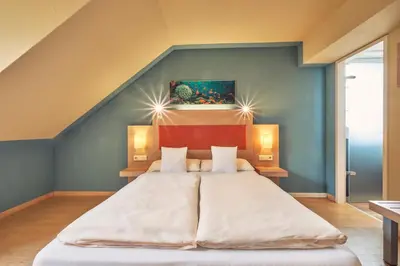 Ein Bett oder Betten in einem Zimmer der Unterkunft AKZENT Hotel Aufkirchen