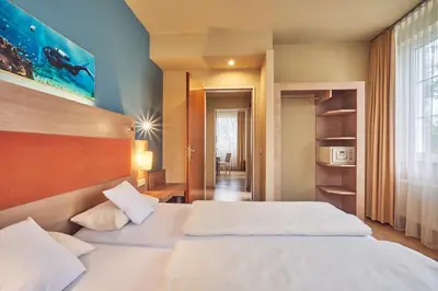 Ein Bett oder Betten in einem Zimmer der Unterkunft AKZENT Hotel Aufkirchen