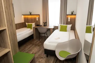 Ein Bett oder Betten in einem Zimmer der Unterkunft Hotel Perlach Allee by Blattl