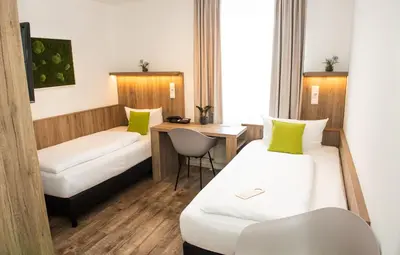 Ein Bett oder Betten in einem Zimmer der Unterkunft Hotel Perlach Allee by Blattl
