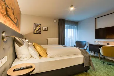 Ein Bett oder Betten in einem Zimmer der Unterkunft Vienna House Easy by Wyndham Ingolstadt
