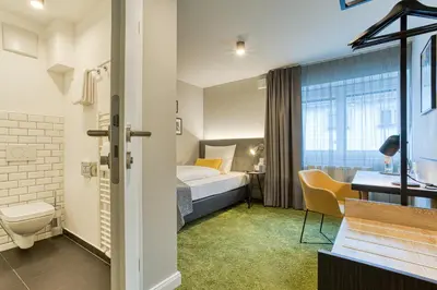 Ein Bett oder Betten in einem Zimmer der Unterkunft Vienna House Easy by Wyndham Ingolstadt