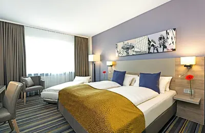 Ein Bett oder Betten in einem Zimmer der Unterkunft Leonardo Hotel Munich City North