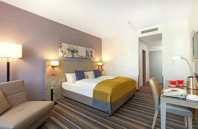 Ein Bett oder Betten in einem Zimmer der Unterkunft Leonardo Hotel Munich City North