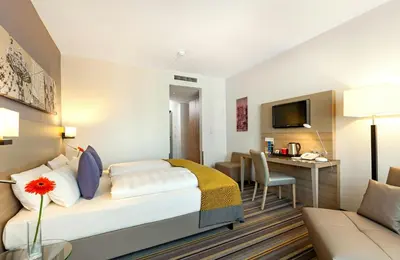 Ein Bett oder Betten in einem Zimmer der Unterkunft Leonardo Hotel Munich City North