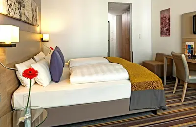 Ein Bett oder Betten in einem Zimmer der Unterkunft Leonardo Hotel Munich City North