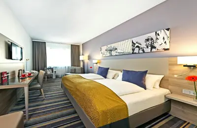 Ein Bett oder Betten in einem Zimmer der Unterkunft Leonardo Hotel Munich City North