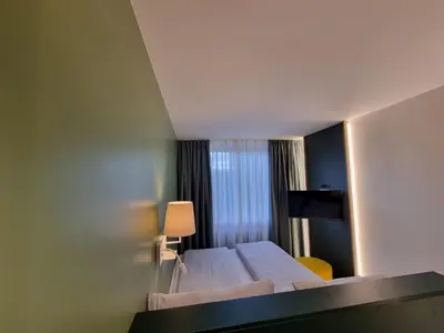 Ein Bett oder Betten in einem Zimmer der Unterkunft myMINGA13 - Hotel & serviced Apartments