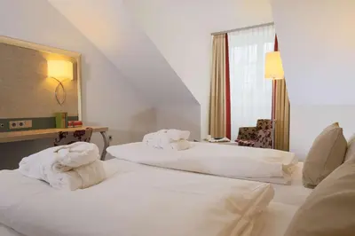 Ein Bett oder Betten in einem Zimmer der Unterkunft Hotel Bayerischer Hof Miesbach, BW Premier Collection