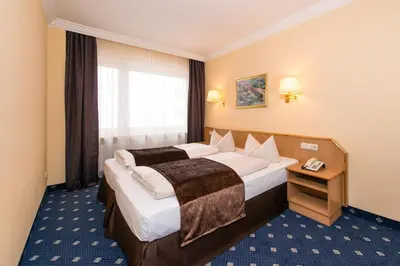 Ein Bett oder Betten in einem Zimmer der Unterkunft Hotel Royal