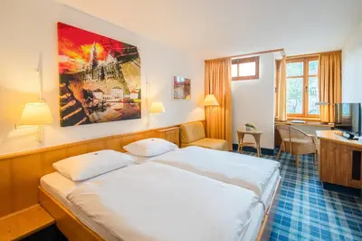 Ein Bett oder Betten in einem Zimmer der Unterkunft Hotel Am Nockherberg