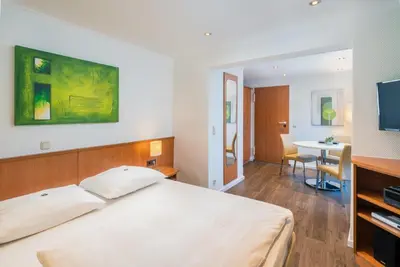 Ein Bett oder Betten in einem Zimmer der Unterkunft Hotel Am Nockherberg